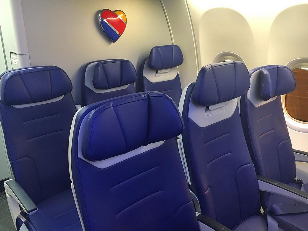 a row of blue chairs in a plane