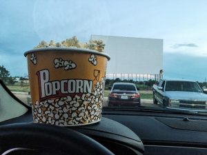 a bucket of popcorn on a car dashboard