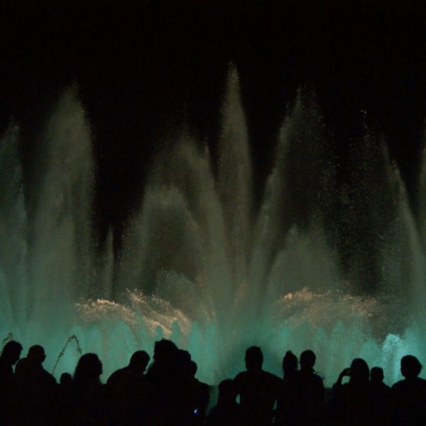 a group of people looking at a fountain