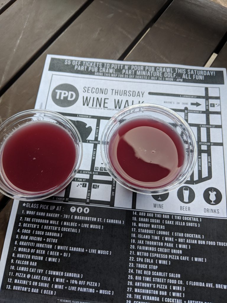 two cups of red liquid on a newspaper