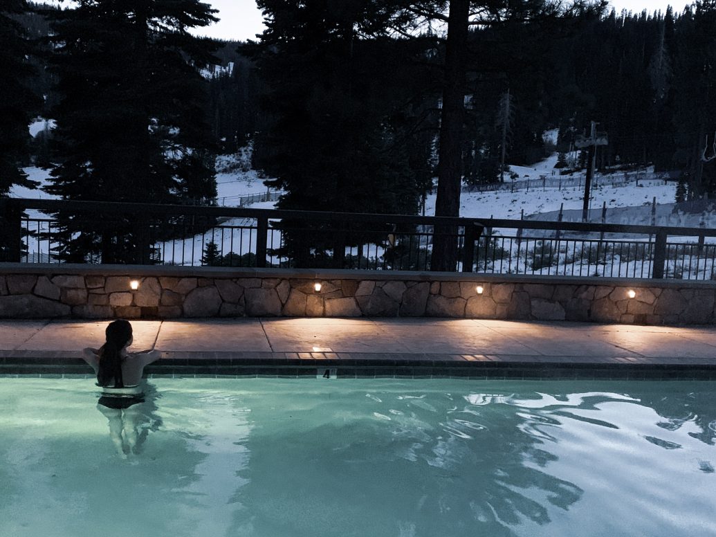 a woman in a pool at night