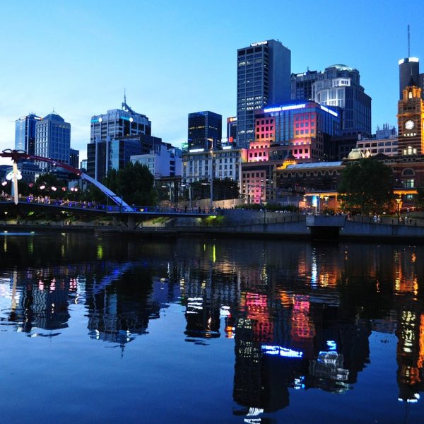 a city skyline with a bridge and a body of water