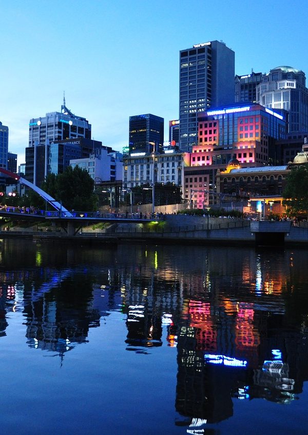 a city skyline with a bridge and a body of water