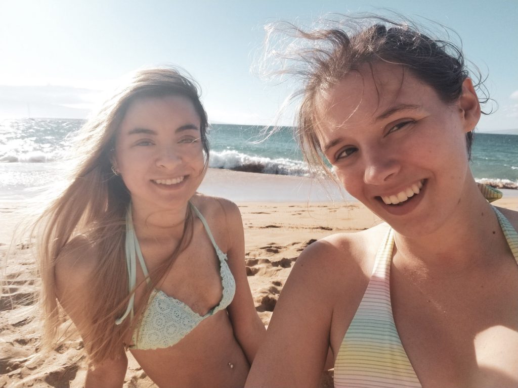 two women taking a selfie on a beach
