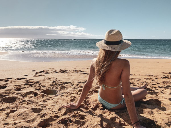 a woman sitting on a beach