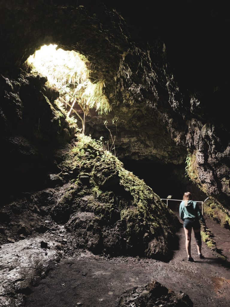 a woman walking in a cave