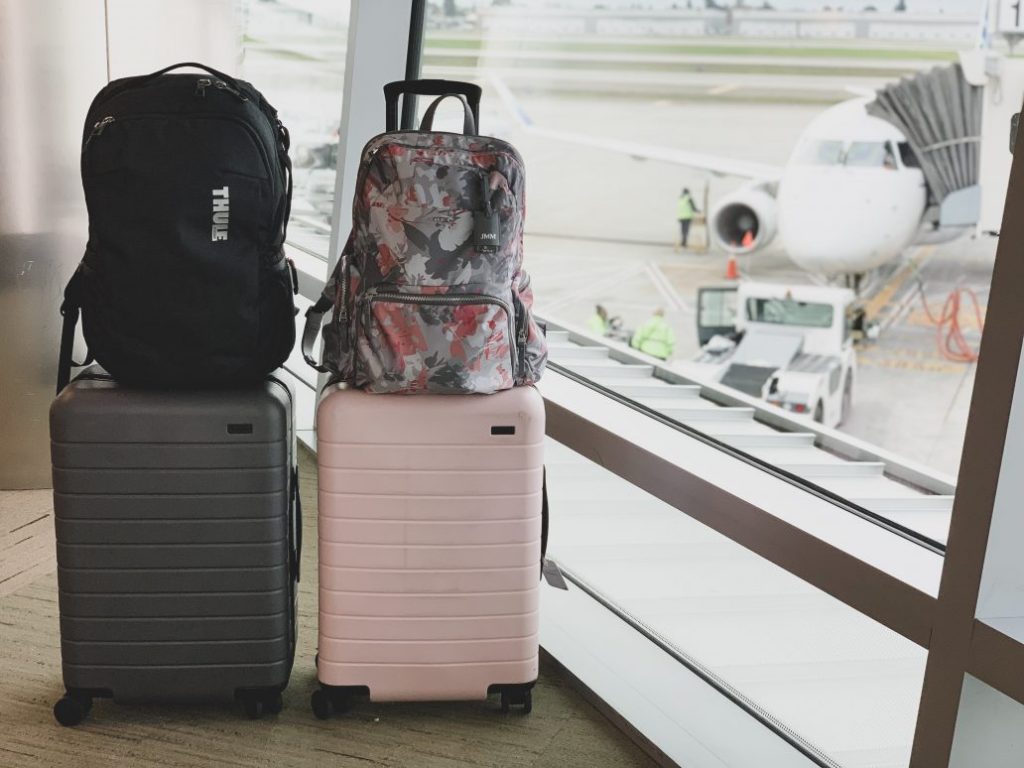 Backpacks with a trolley sleeve staying upright  on a suitcase