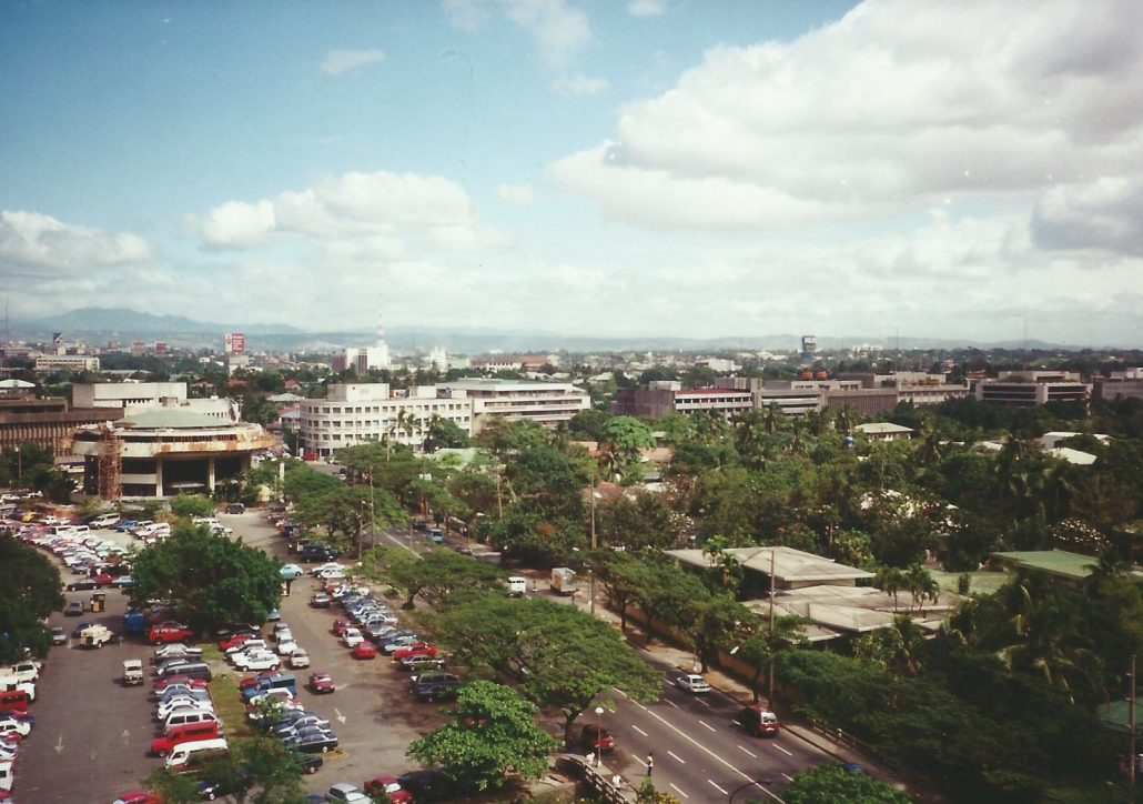 a city with cars and trees