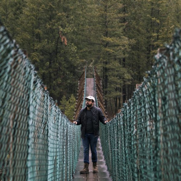 a man walking on a bridge