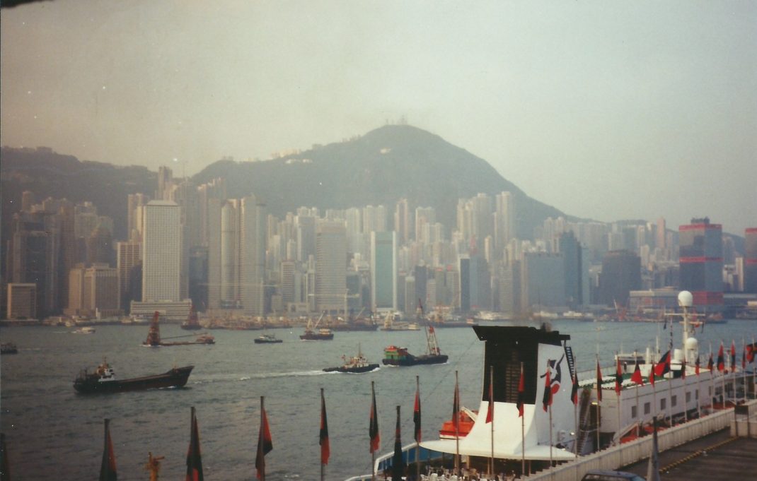 a city skyline with boats and ships