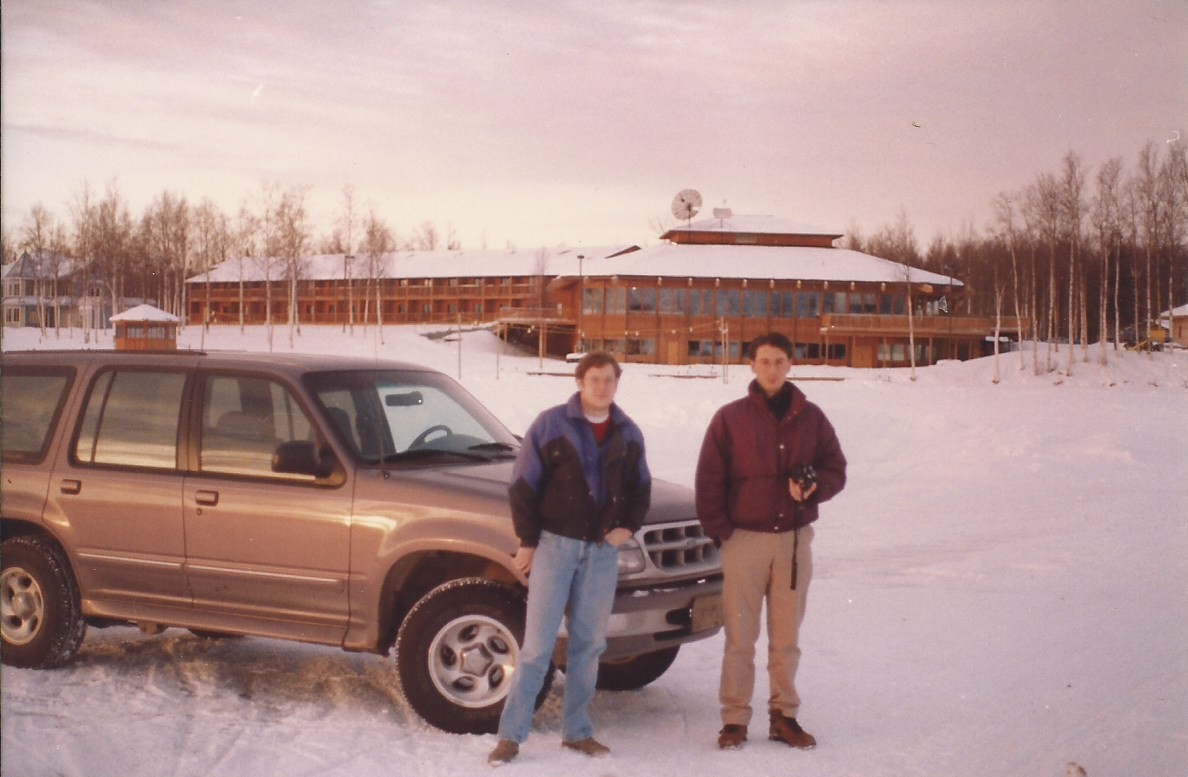 two men standing in the snow