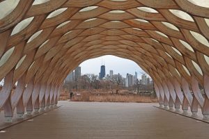 a wooden structure with a city in the background