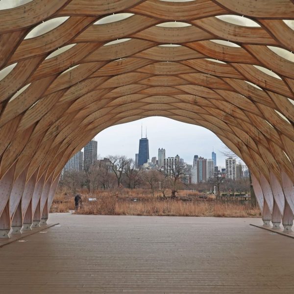 a wooden structure with a city in the background