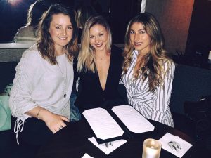 a group of women sitting at a table