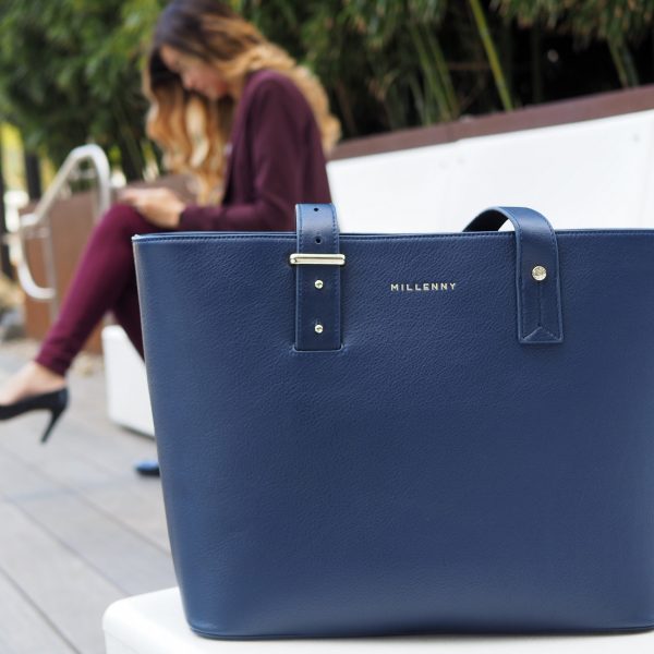 a blue purse on a bench