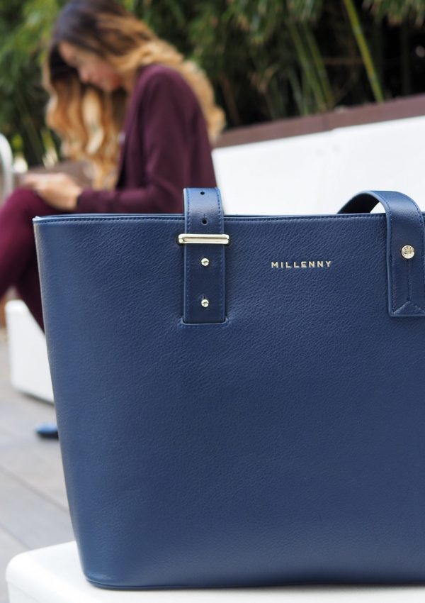 a blue purse on a bench