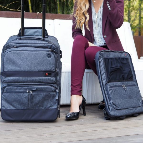 a woman sitting on a bench with luggage