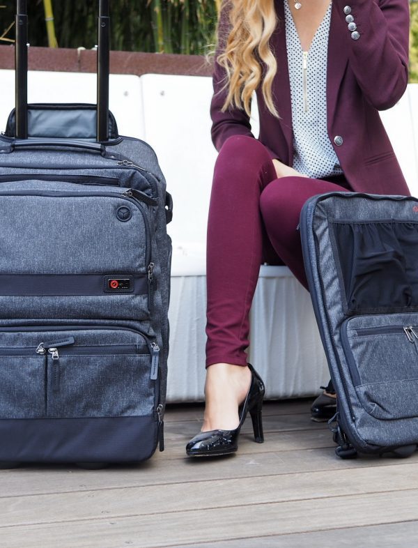 a woman sitting on a bench with luggage