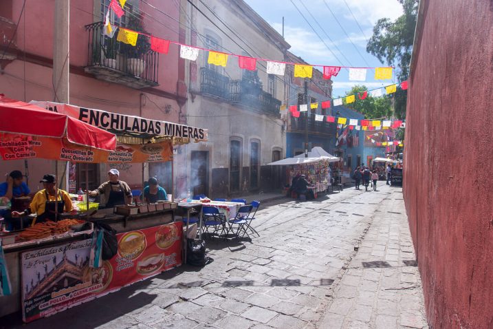 a street with food vendors and people