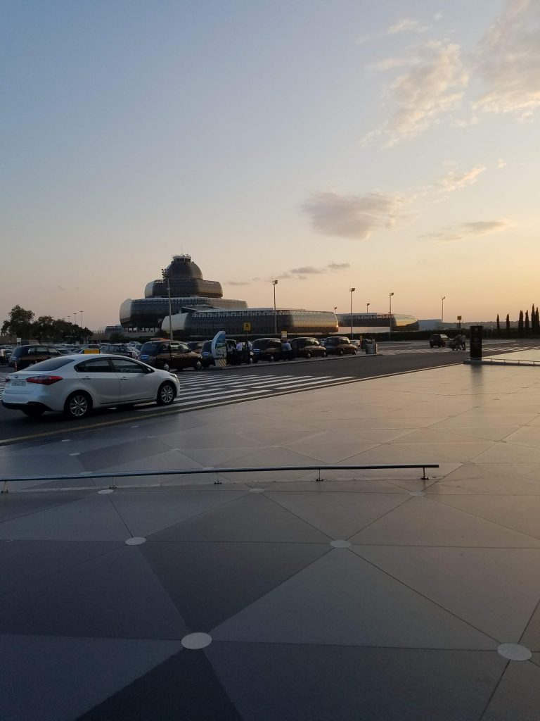 a large building with cars parked on a street