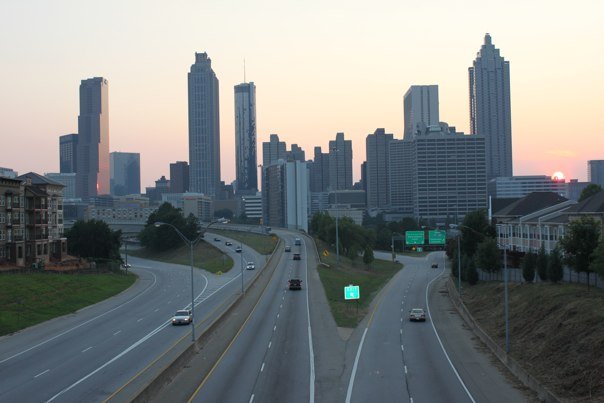 a highway with a city skyline in the background