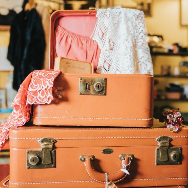 a stack of suitcases with lace and clothes