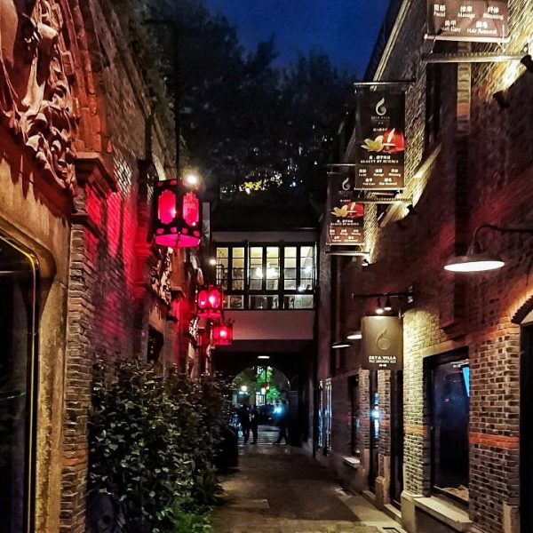 a street with red lights and signs