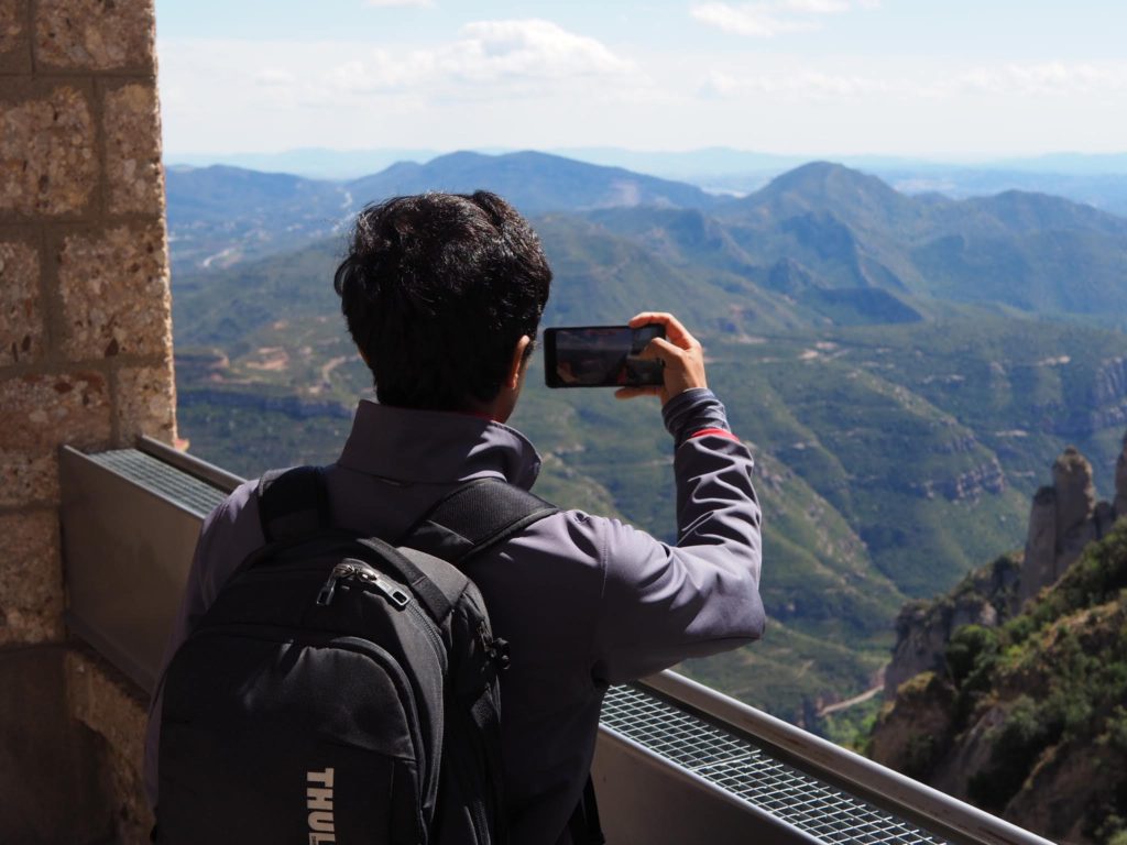 a man taking a picture of a valley