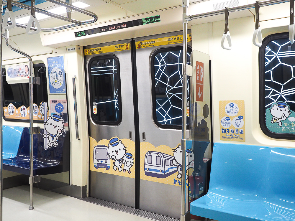 a train with doors and a blue seat