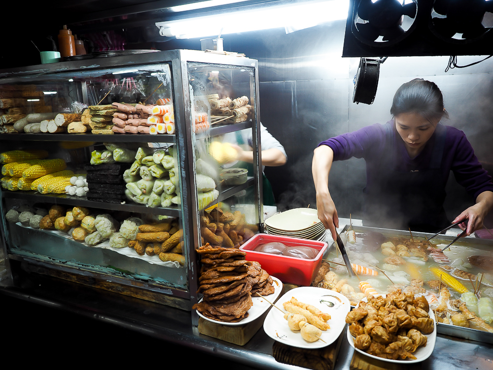 a woman cooking food in a restaurant