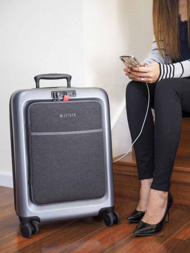 a woman sitting on a staircase with a suitcase