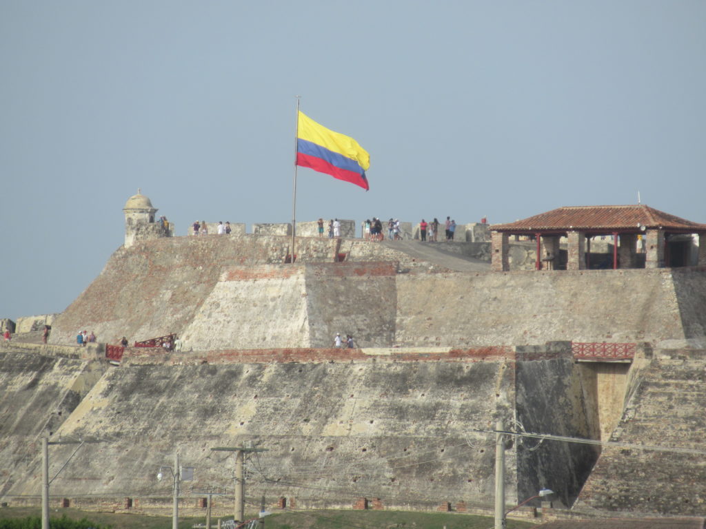 a flag on a flagpole on a stone wall