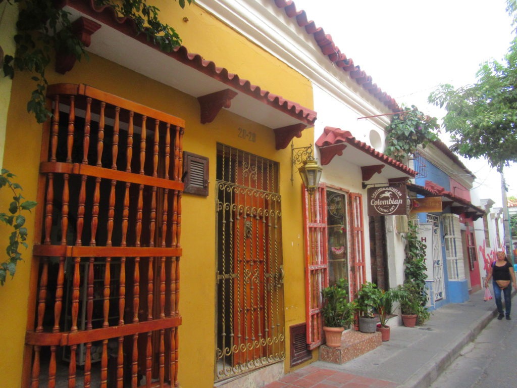 a row of buildings with a gate and plants