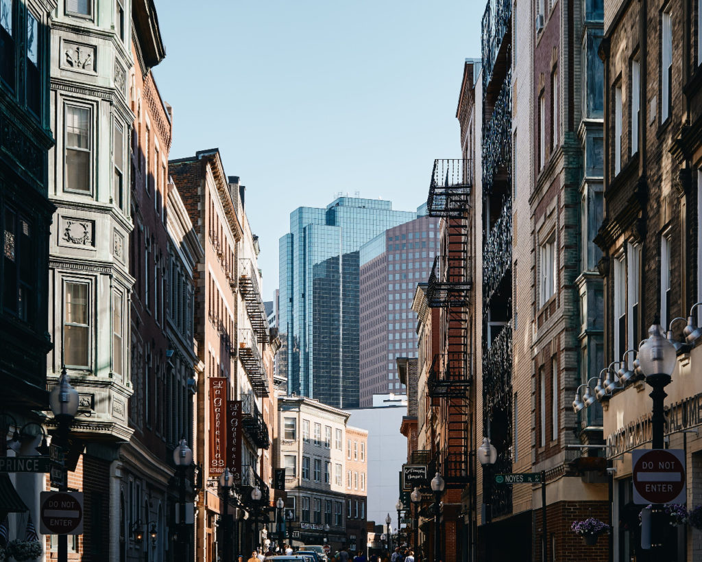 a city street with buildings and people