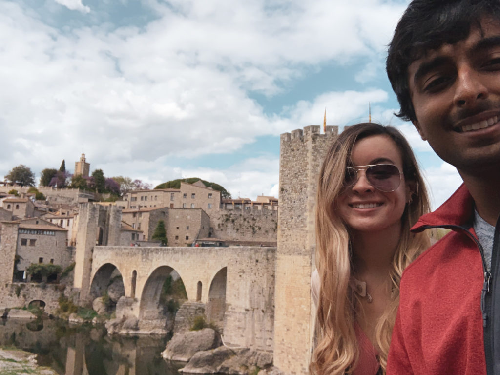 a man and woman taking a selfie in front of a castle