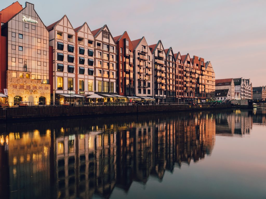 a row of buildings next to a body of water