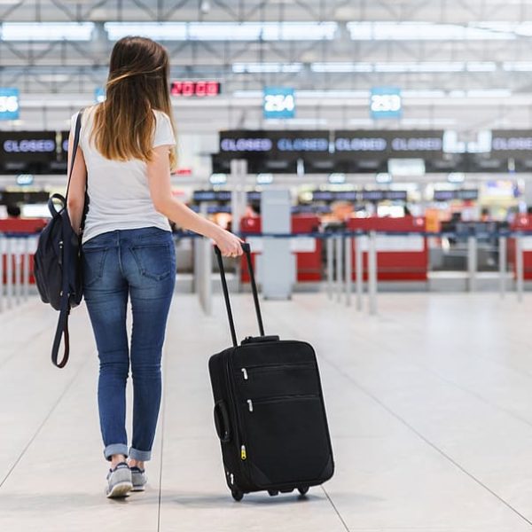 a woman walking with a suitcase