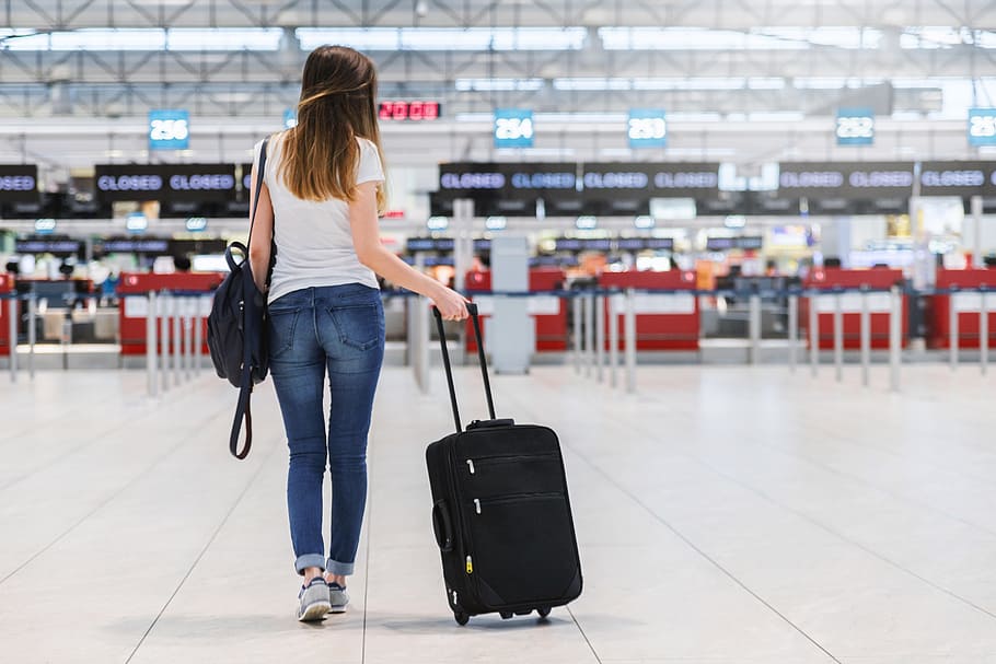 a woman walking with a suitcase