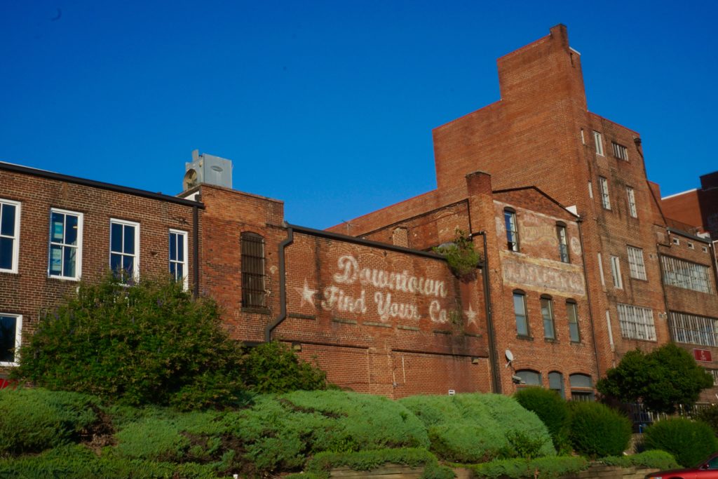 a brick building with a sign on the side