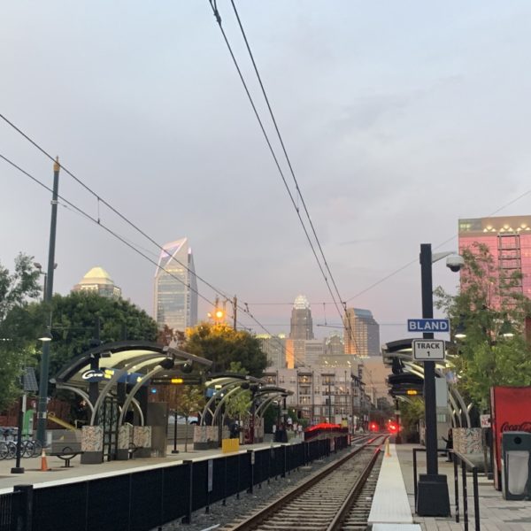 a train tracks with a city in the background