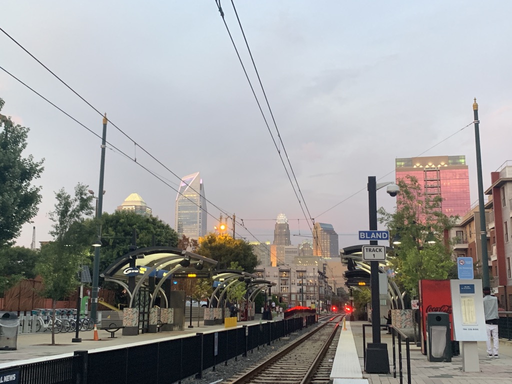 a train tracks with a city in the background