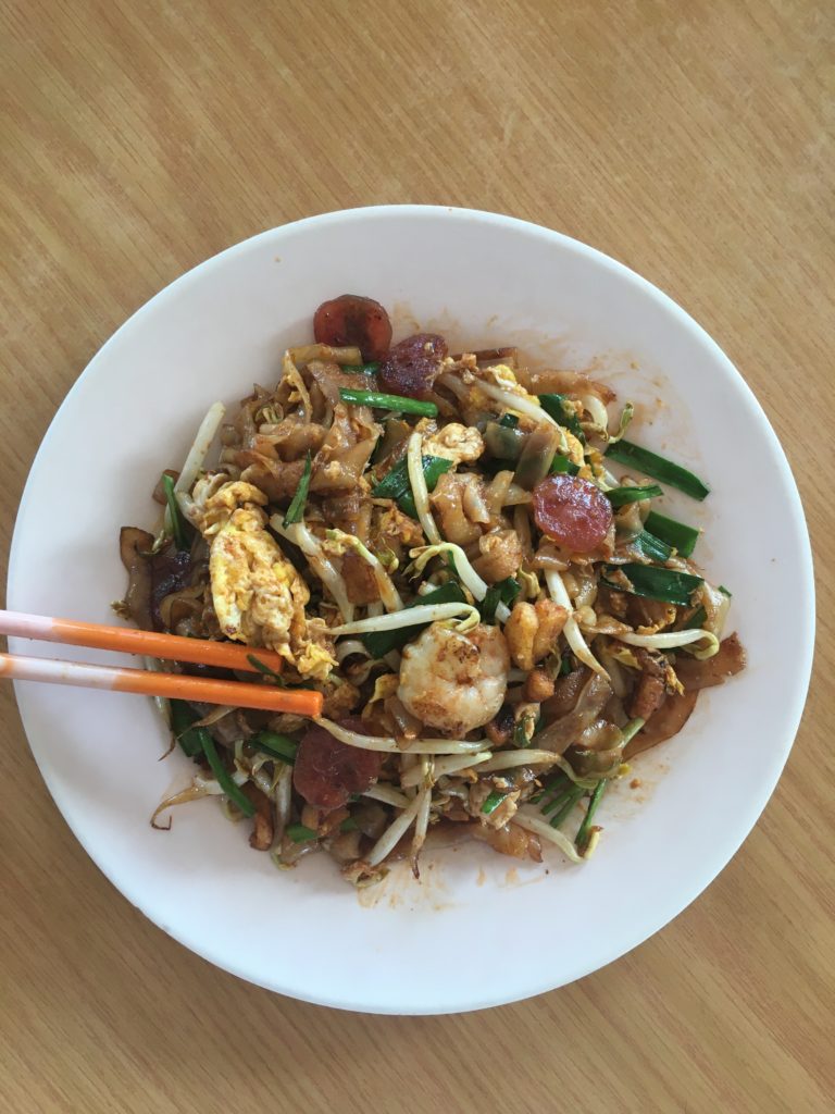 a plate of food with chopsticks