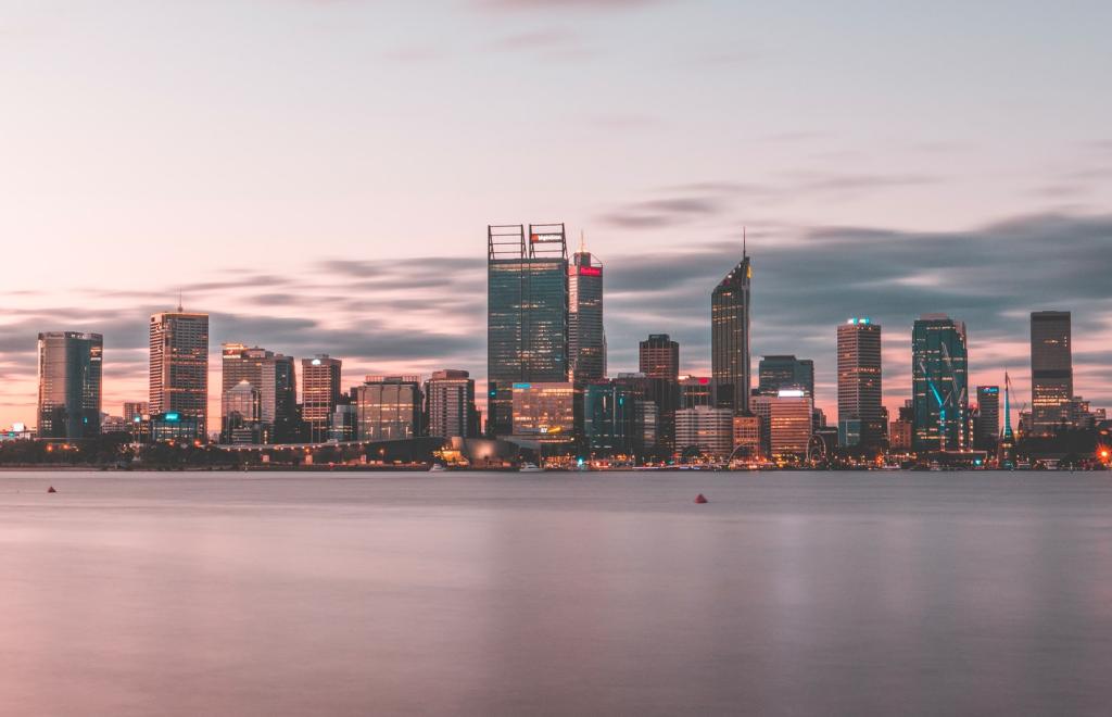 a city skyline with a body of water