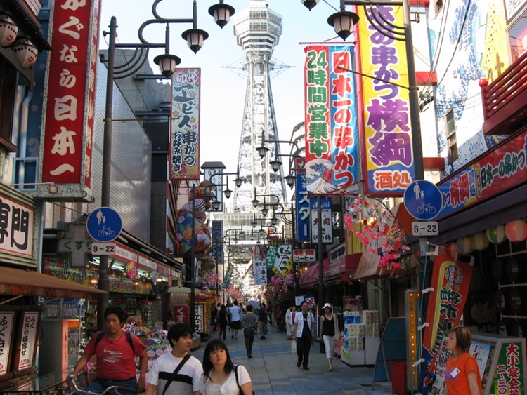 a street with signs and people walking