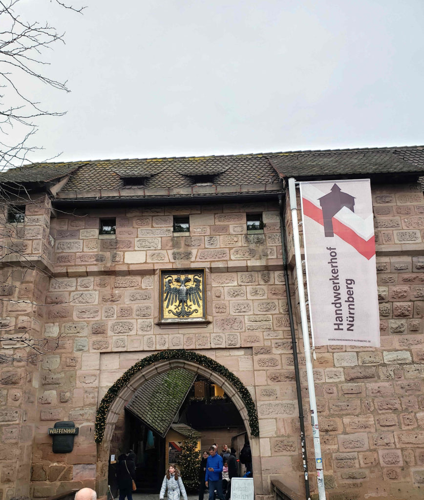 a stone building with a flag and a sign