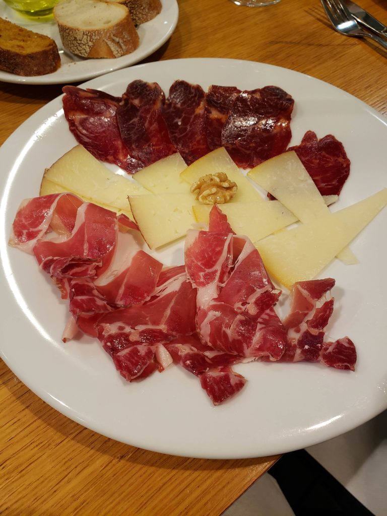 a plate of meat and cheese