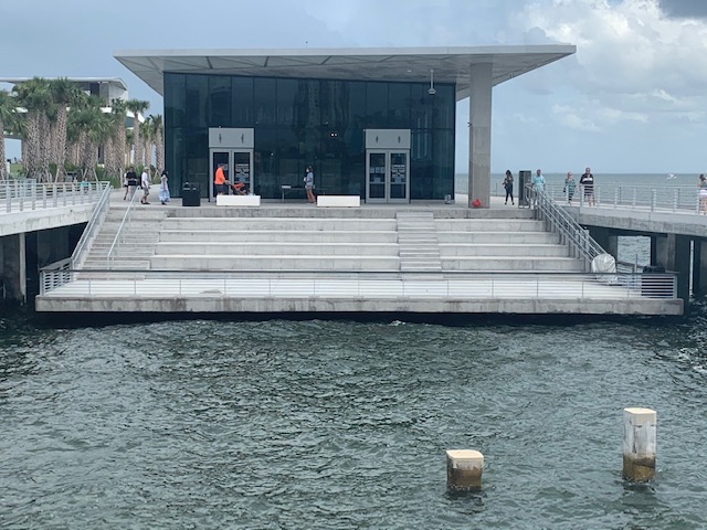 a building with stairs leading to the water