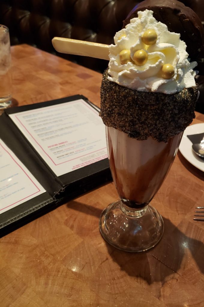 a glass with a dessert on top