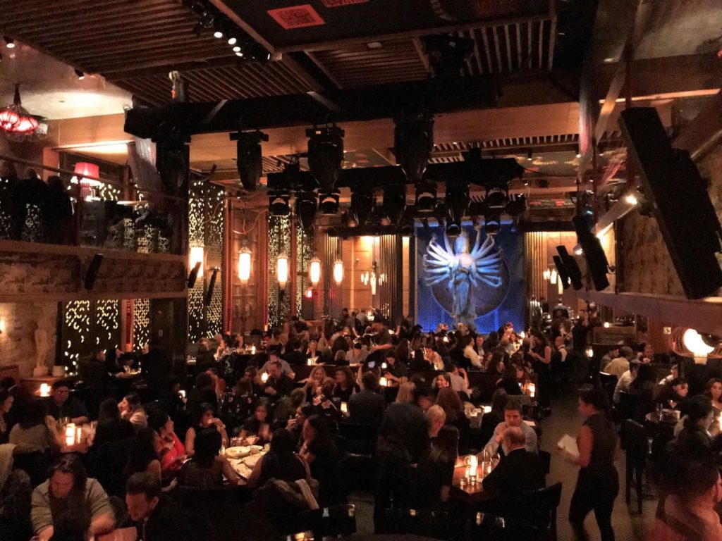 a group of people sitting at tables in a restaurant