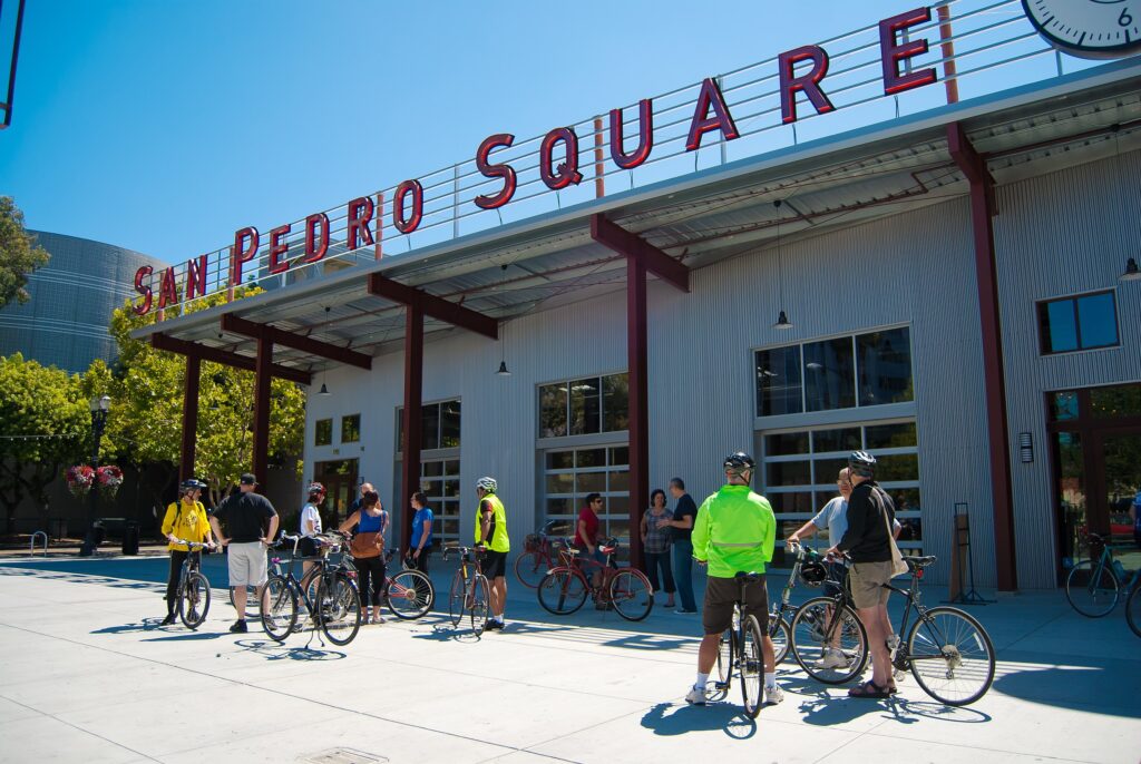 a group of people on bicycles outside of a building